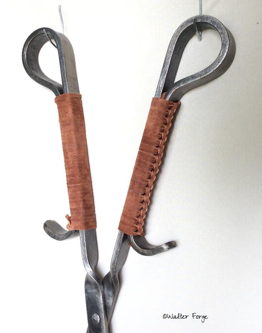 Braided suede handles give a comfortable grip to these fire tongs.